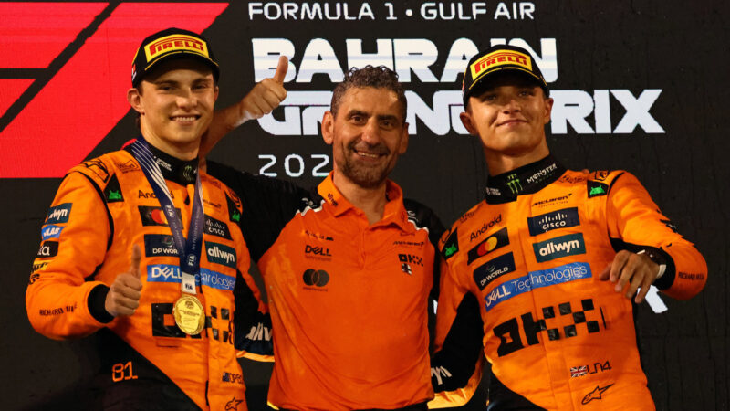 Oscar Piastri, Lando Norris, Andrea Stella (all McLaren-Mercedes) on the podium after the 2025 Bahrain Grand Prix